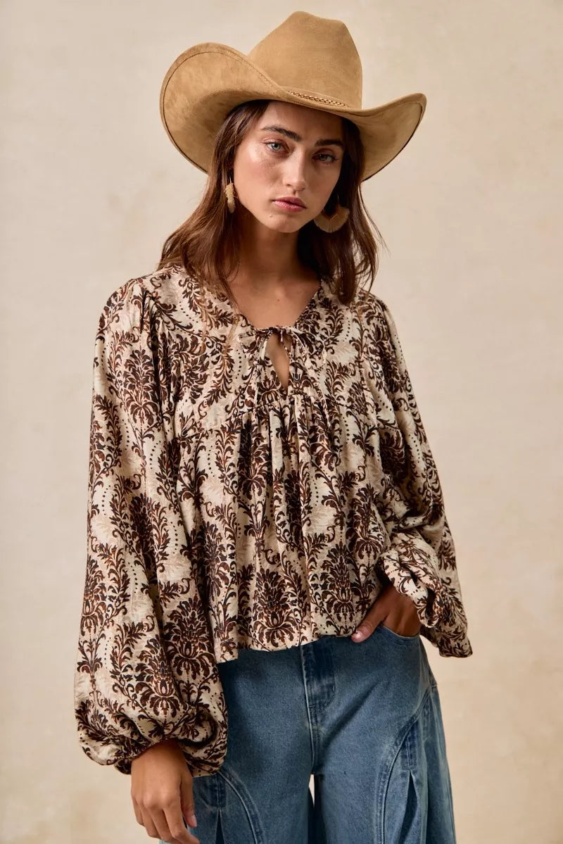 Sarah Express women’s printed blouse featuring a front tied detail and romantic balloon sleeves.