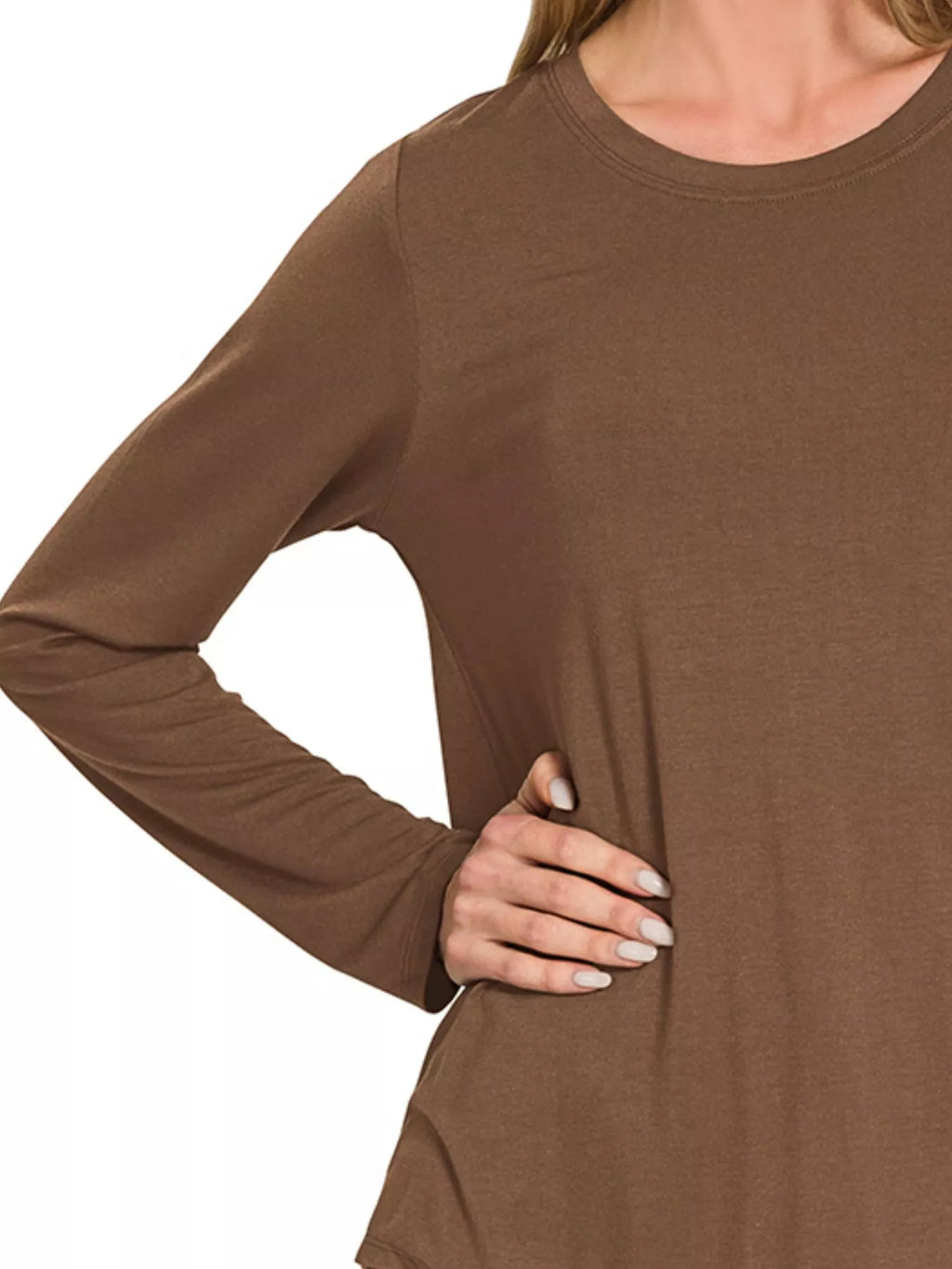 Brown long-sleeve top worn by a person on a white background