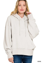 Women's bone colored oversized fleece hoodie with kangaroo pocket and drawstring hood
