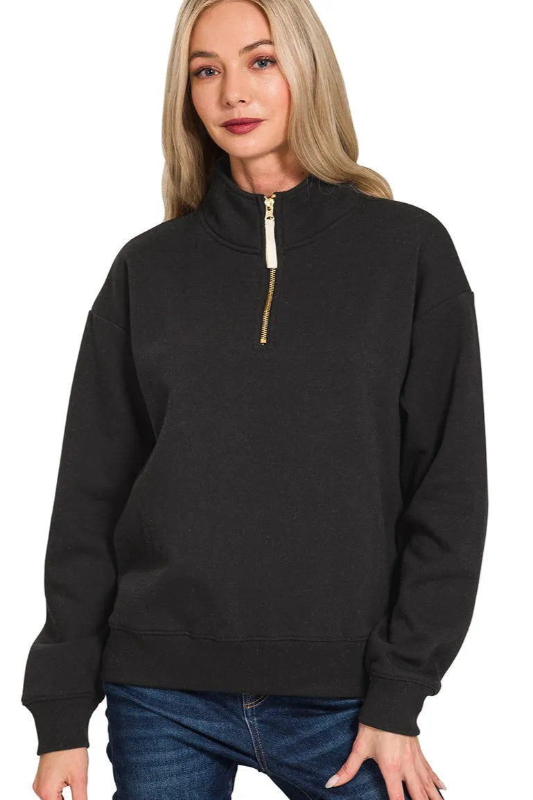 Black half-zip sweatshirt worn by a person on a white background
