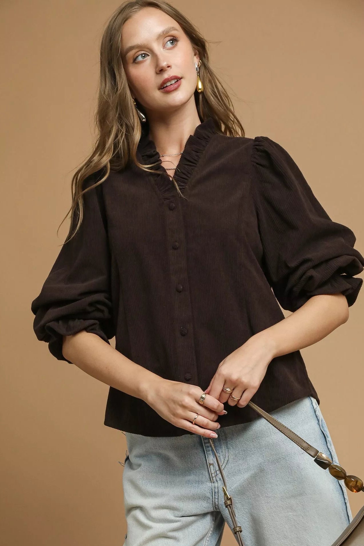 Sarah Express women’s oversized corduroy shirt with ruffle details at the neckline and long puff sleeves.
