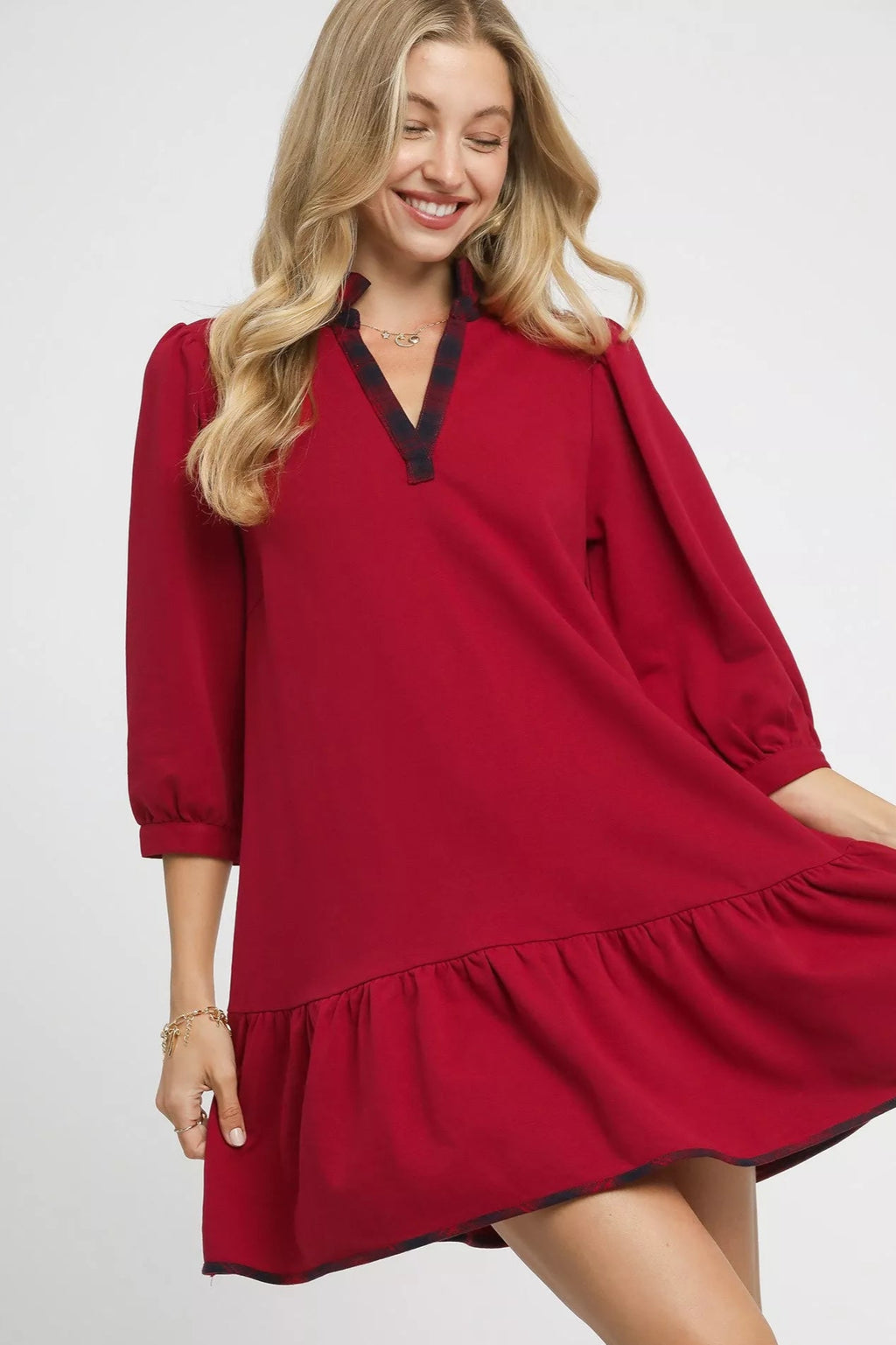 Woman wearing a red dress with a white background