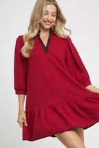 Woman wearing a red dress with a white background