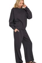 Woman wearing a black tracksuit on a white background
