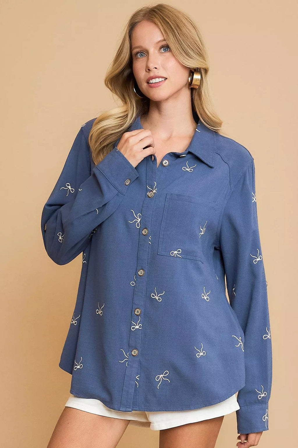 Sarah Express women’s fitted linen blend shirt with intricate ribbon embroidery details.