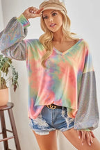 Sarah Express women’s oversized tie-dye French terry top with a V-neck and shimmer details.
